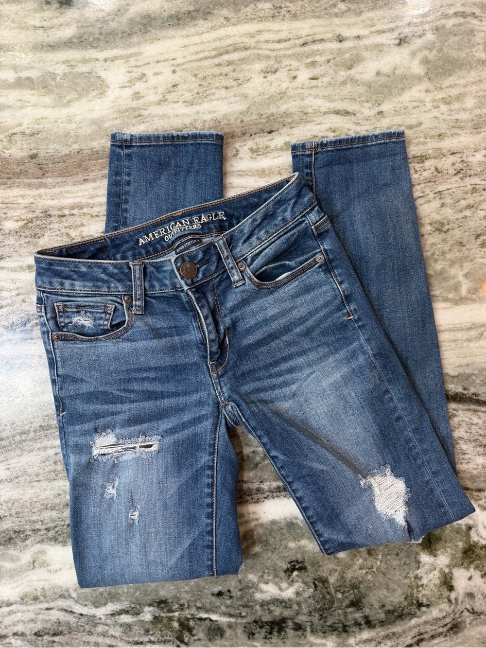 American Eagle Dark Blue Ripped Skinny Jeans for Women
Size 0 Reg